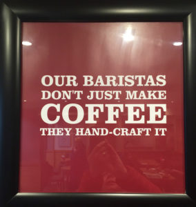 Costa sign reads, “Our baristas don’t just make coffee, they hand-craft it.”.